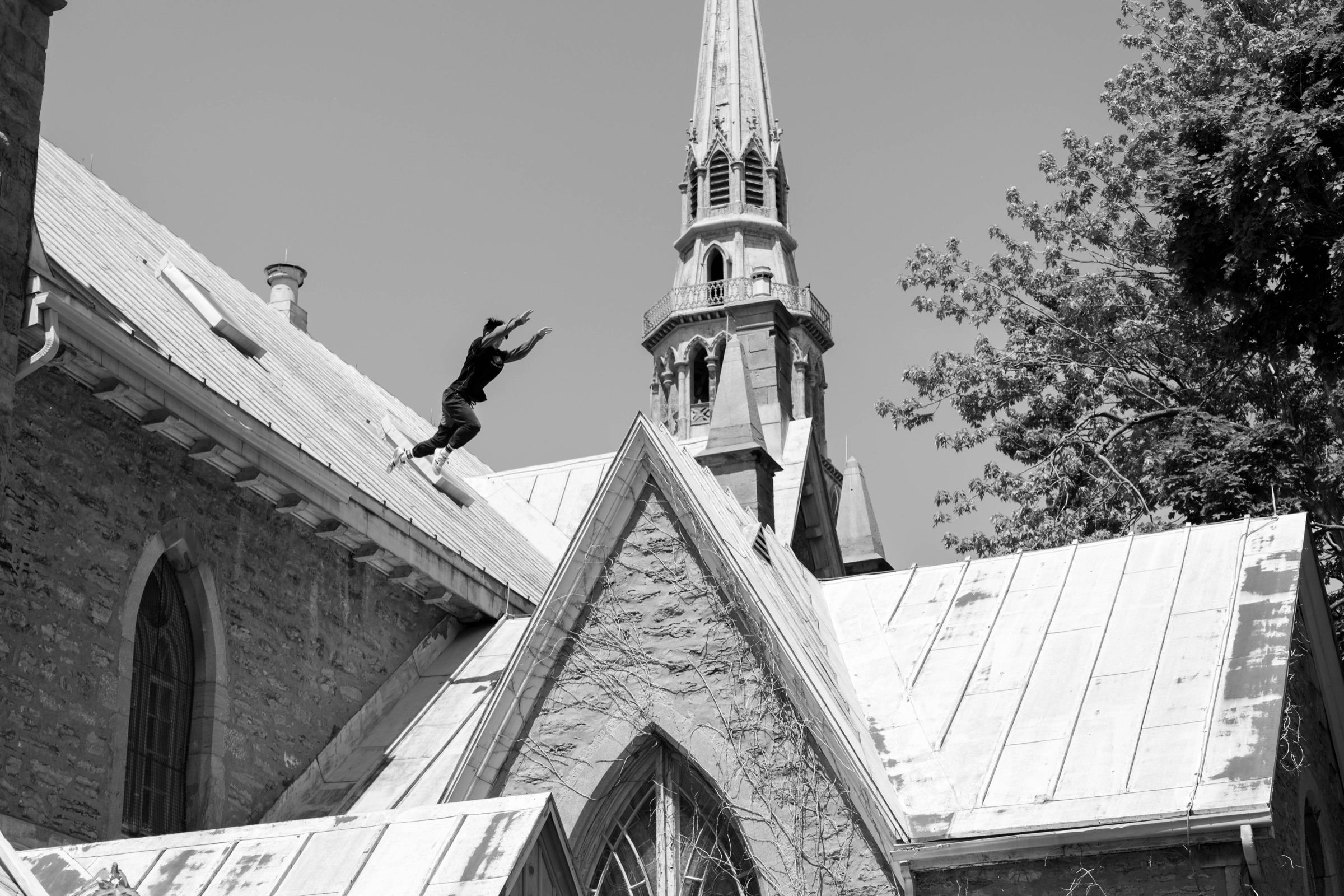 Dylan Cheung jumping a gap on top of a church during his descent line